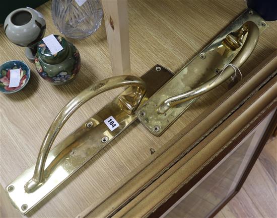 A pair of brass Art Nouveau door handles